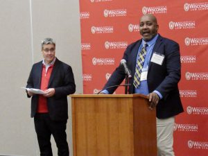 A Hastie Fellow speaks at a podium.