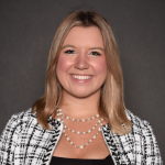 A blonde woman smiling.