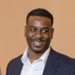 A black man smiling.