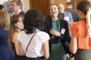 A woman laughs with a group of other women.
