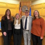 small photo of a group of people in a courtroom