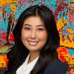 Photo of beautiful young asian woman with bronze skin tone and long dark hair wearing business attire