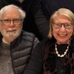 Photo of two senior folks together - a man and a woman, both wearing winter attire
