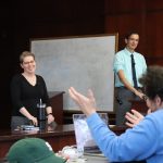 photo of two professors by a whiteboard