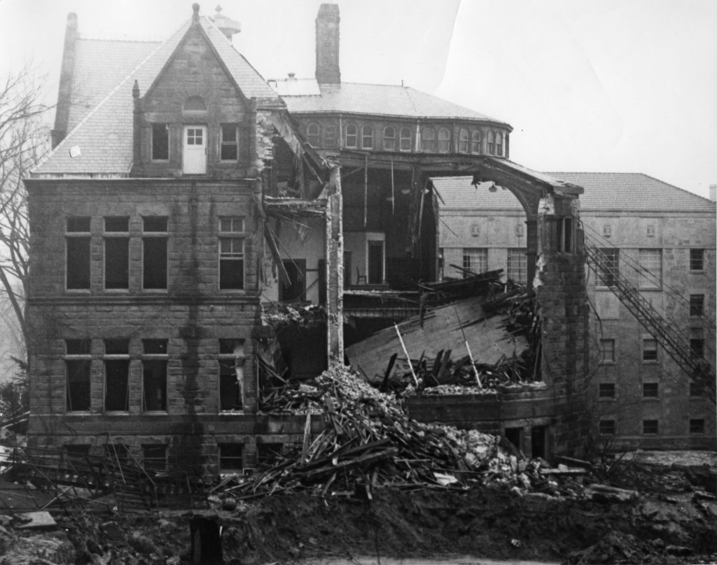 Black and white photo of exterior of old Law Building. Part of it is demolished.