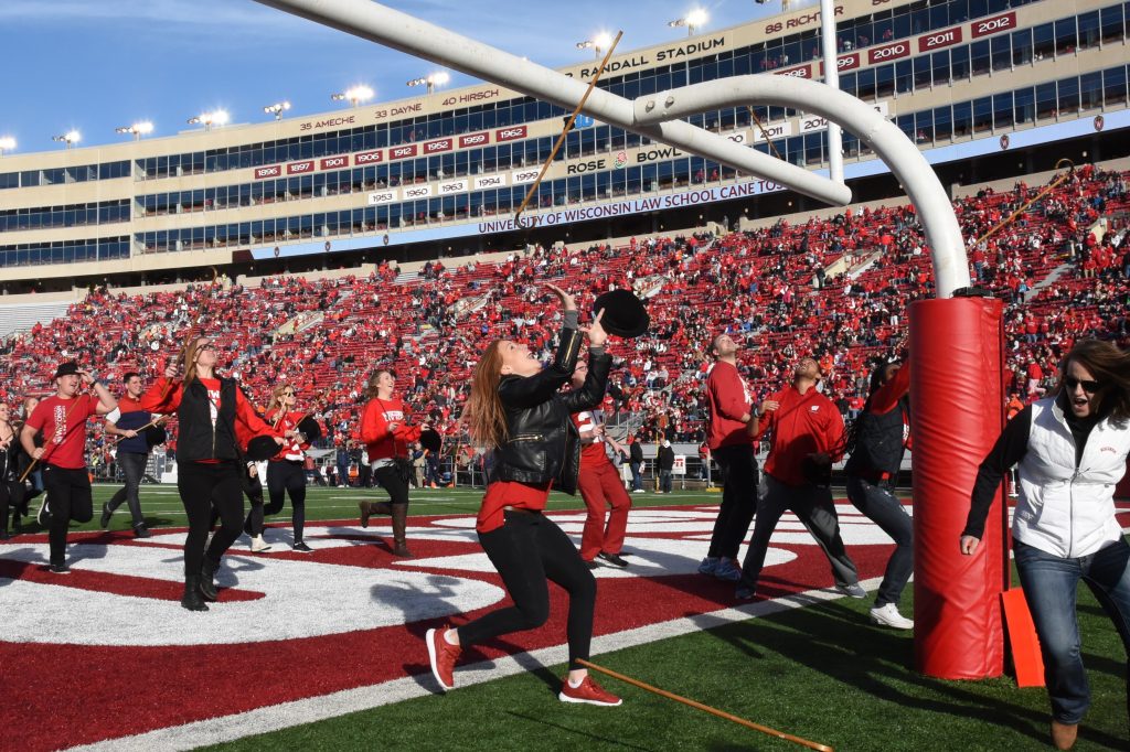 Students tossing their canes over the field goal on Camp Randall, 2016