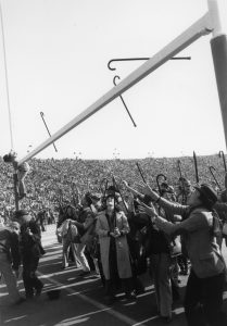 student tossing their cane on camp randall