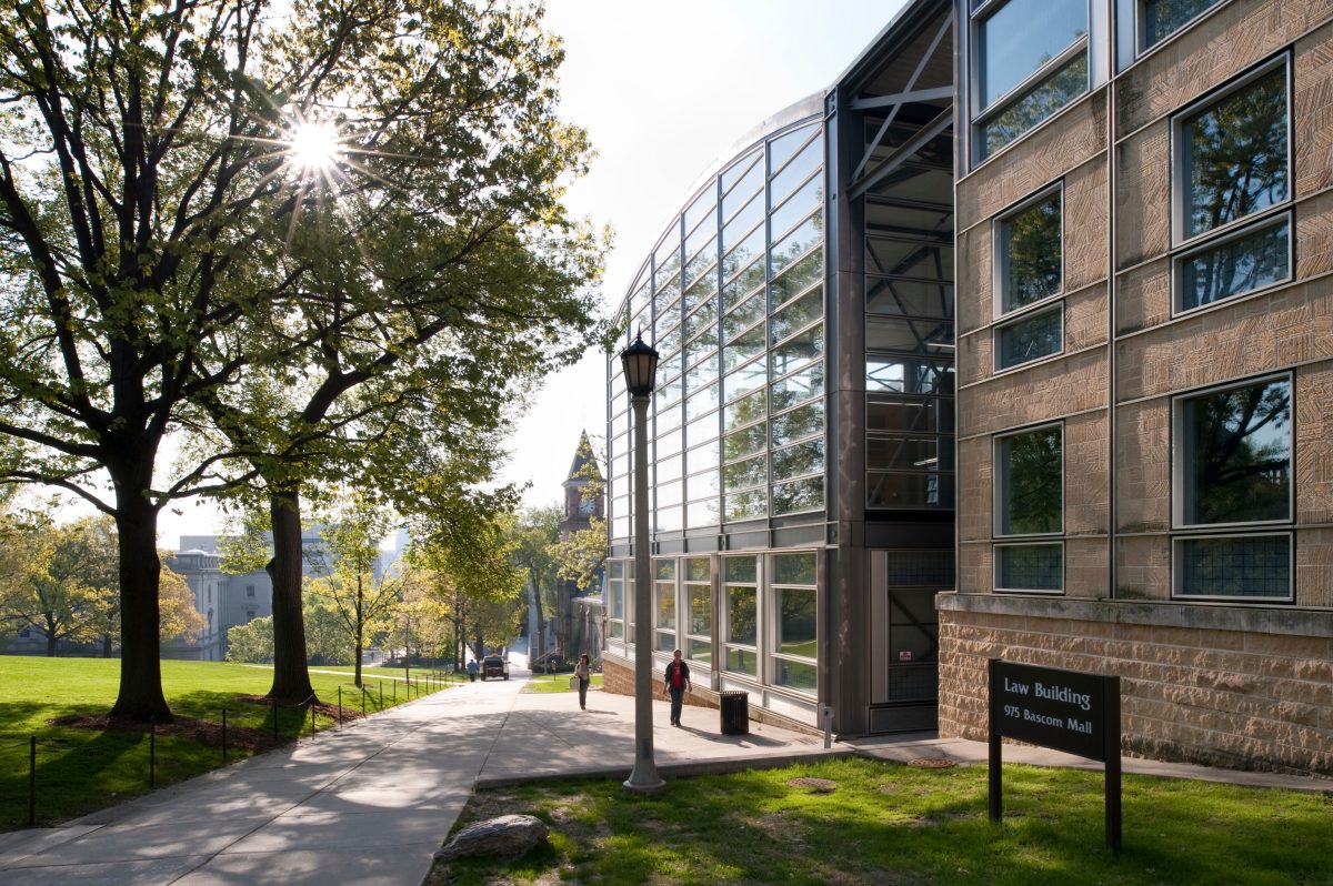 Pedestrians walk past the Law Building