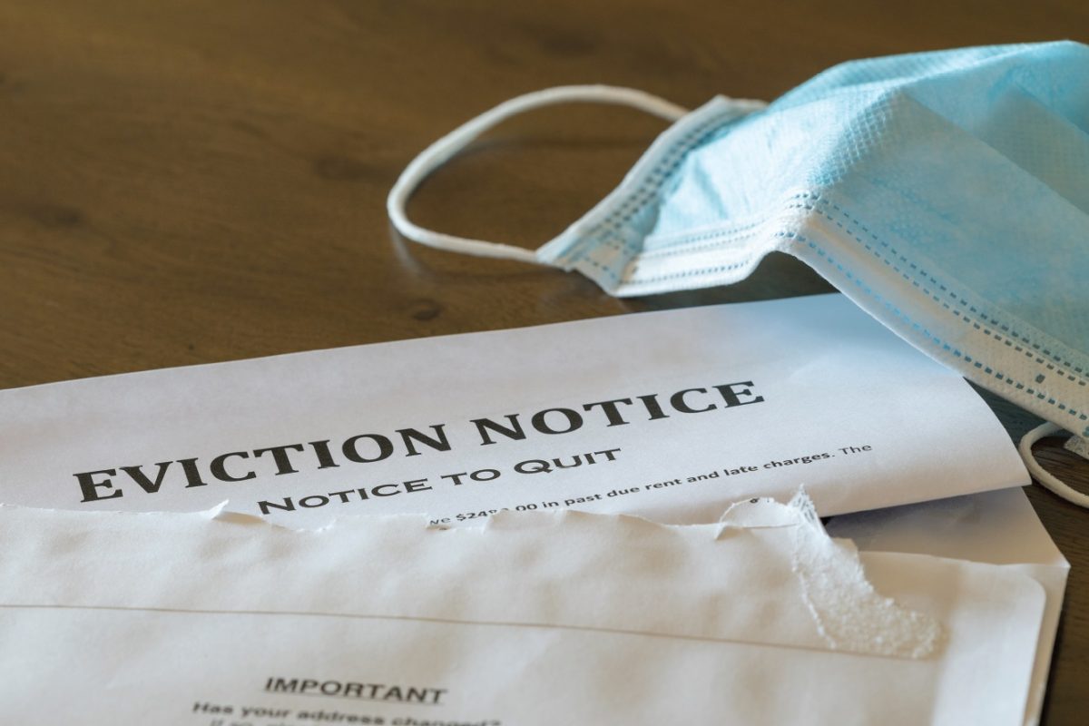 picture of eviction notice paper with a mask next to it