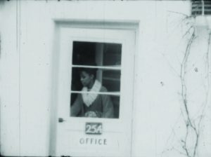black woman leaving an apartment rental office