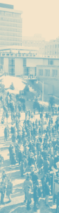 Old photograph of crowd gathered outdoors on UW–Madison campus to protest during Vietnam War era, with a building in the background.