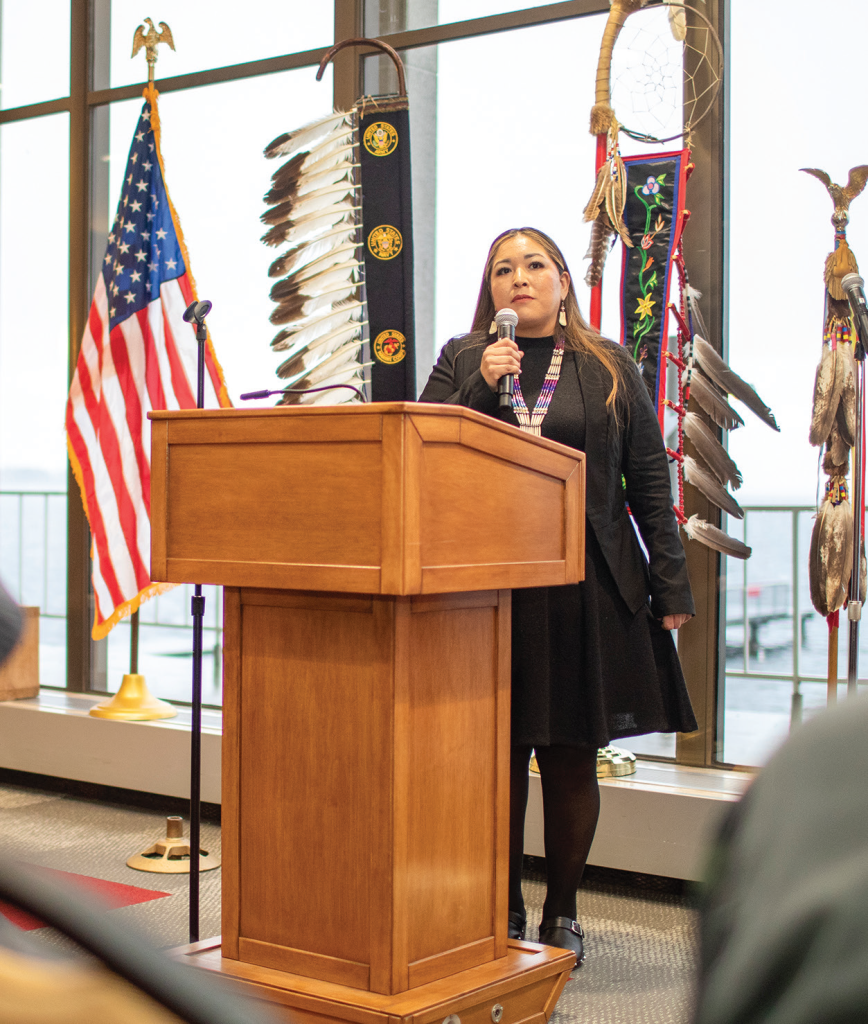 Person speaking at podium with a microphone.