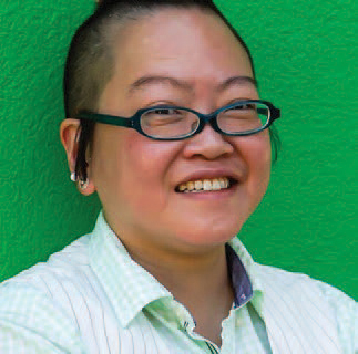 A headshot image of Steph Tai, wearing glasses and smiling