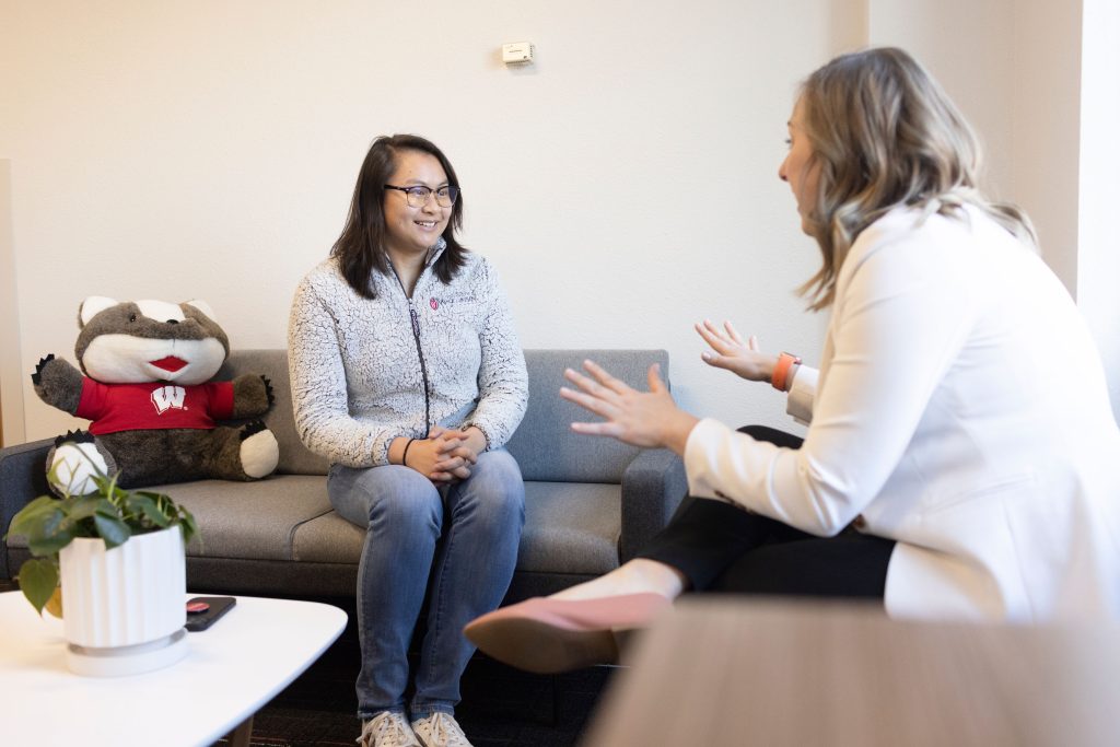 Staff speaks to a female student.