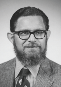 A black and white headshot photo of Ted Finman
