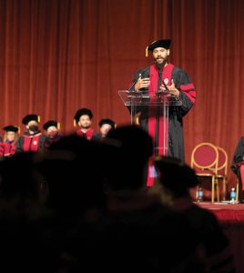 Damon Terrell, a graduating student of color, speaks to the crowd at the graduation ceremony.