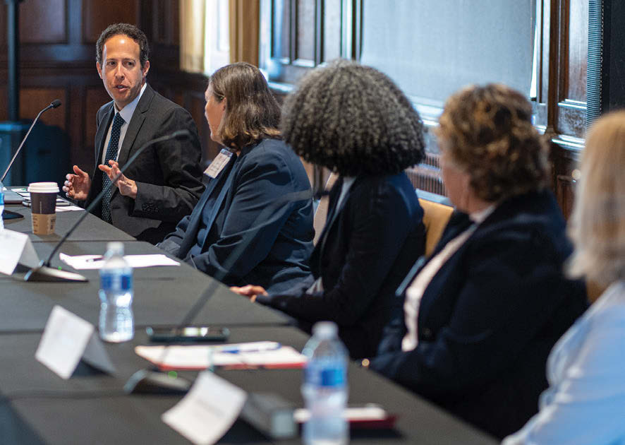 A man speaks to a group of diverse women at a table. Associate Professor Robert Yablon leads a panel discussion with state supreme court justices for State Democracy Research Initiative’s “Public Law in the States: The Work of State Supreme Courts” event June 2, 2023, at Memorial Union on the UW–Madison campus.