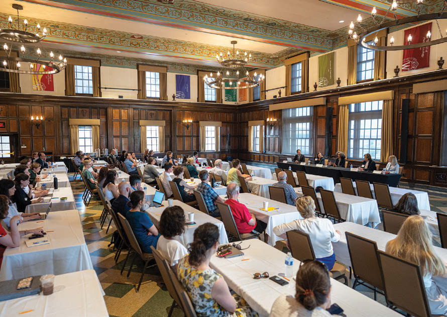 An ornately trimmed room is filled with rows of tables, at which attendees are seated. Associate Professor Robert Yablon leads a panel discussion with state supreme court justices for State Democracy Research Initiative’s “Public Law in the States: The Work of State Supreme Courts” event June 2, 2023, at Memorial Union on the UW–Madison campus.