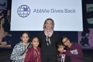 Laura Schumacher stands with four children at an event.