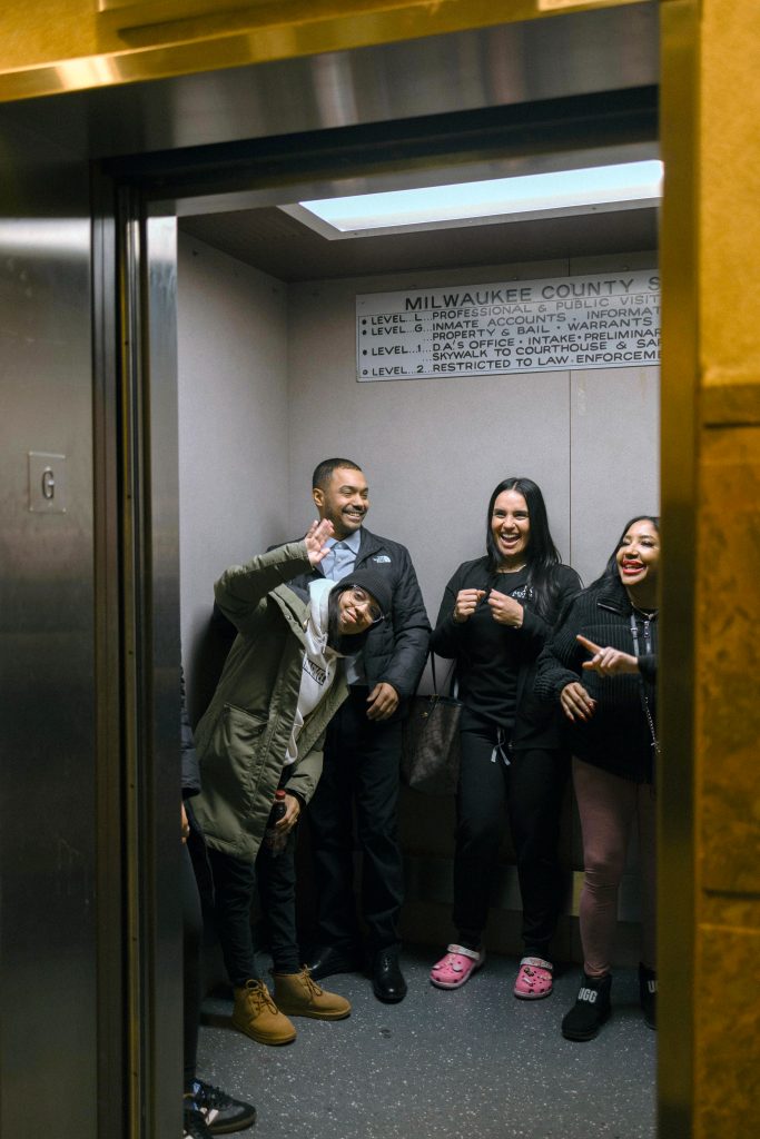 Manuel Cucuta smiles while leaving in an elevator with his loved ones.