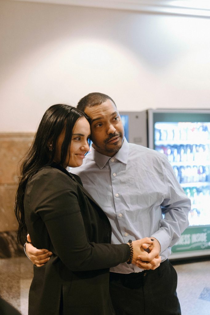 Manuel Cucuta hugs his girlfriend and holds her hand.