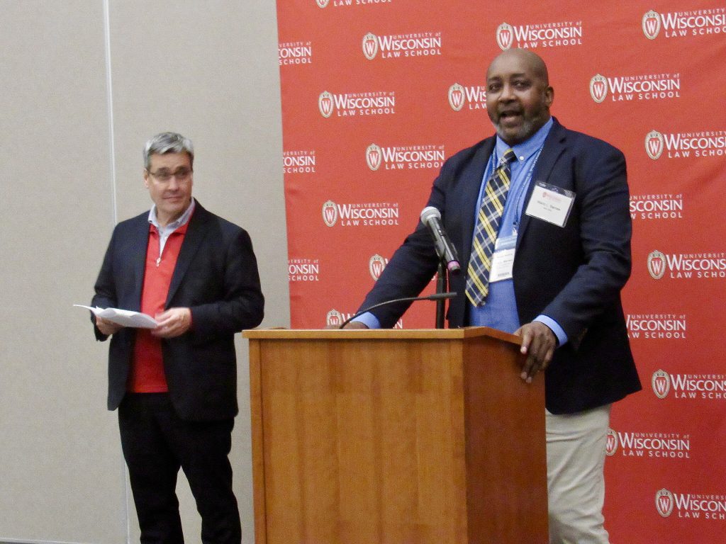 A Hastie Fellow speaks at a podium.