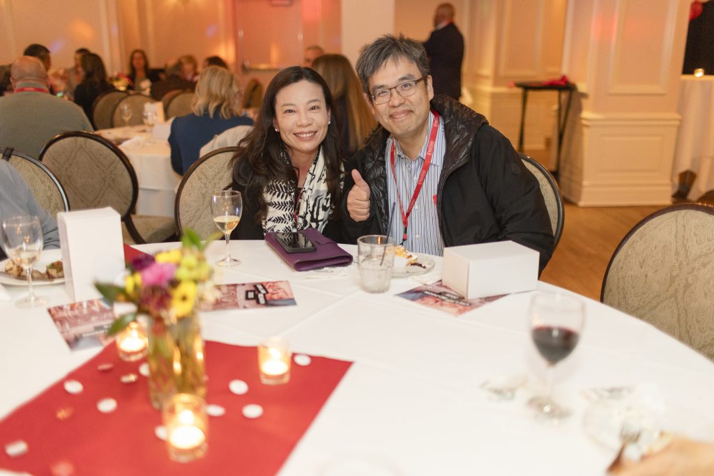 A man and a woman sit at a table.